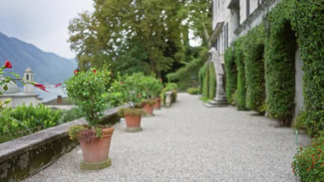 Lake como garden terrace path in soft bokeh defocused background garden; background backplate copyspace calm.