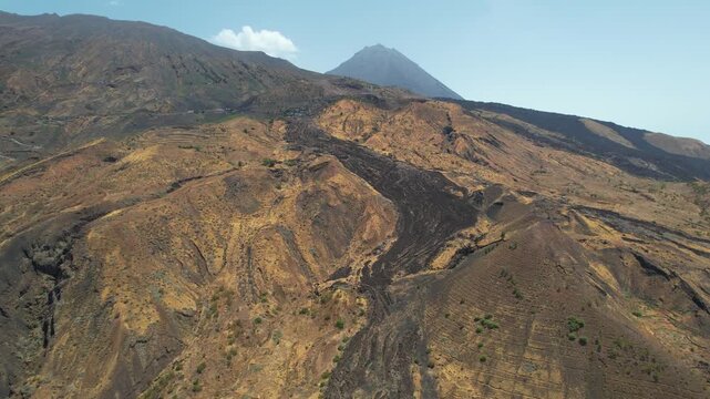 CAPE VERDE - 9.4.2025 - Wonderful aerial view of Cape Verde's Pico do Fogo volcano cresting over a hill on its island.