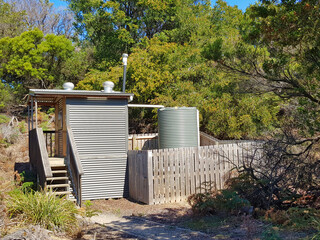 New bush toilet with tank for rainwater in a nature reserve in Tasmania. Waterhouse Conservation Area, Bridport, Northeast Tasmania, Australia. 
