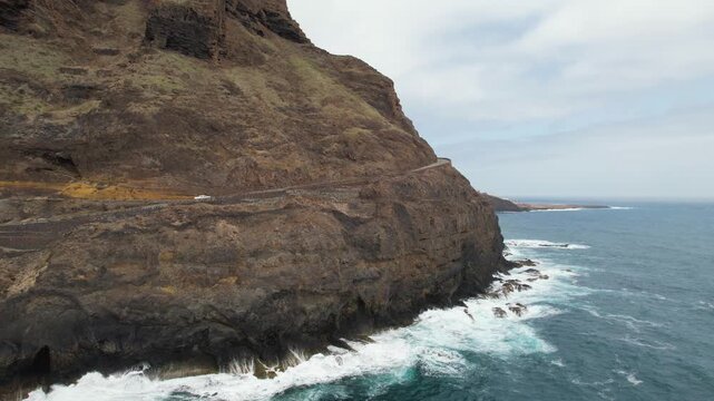 CAPE VERDE - 9.4.2025 - Excellent aerial footage following a truck as it winds along the coast of Cape Verde's Santo Antao island.