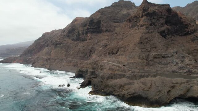 CAPE VERDE - 9.10.2025 - Great aerial footage following a car as it drives along the rugged coastline of Cape Verde's Santo Antao island.