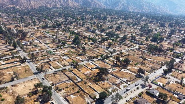 LOS ANGELES - 9.10.2025 - Aerial footage drawing back from the Altadena mountains to show a neighborhood in Los Angeles where every home has been eradicated by the Eaton wildfires.