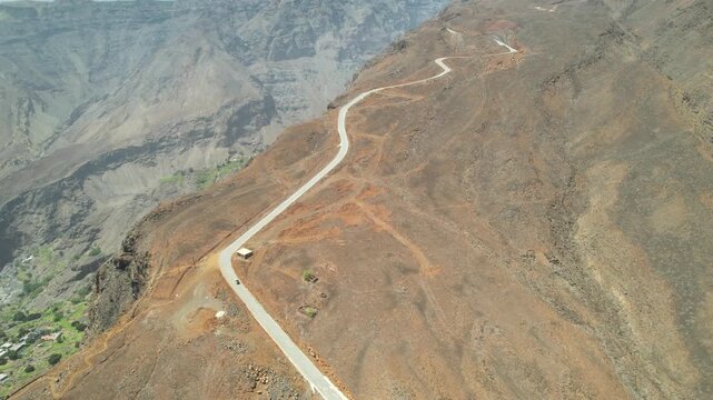 CAPE VERDE - 9.10.2025 - Stunning aerial footage of a car driving along a winding canyon road on Cape Verde's Santo Antao island.