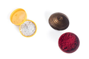 Colorful powders in open containers, white thiruneer powder and kumkum powder are part of the Hindu culture