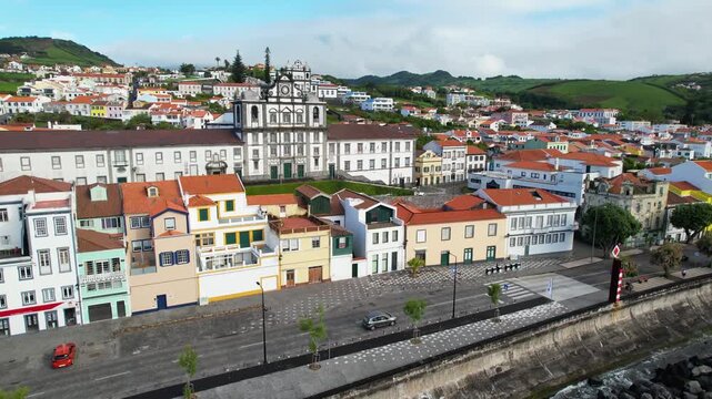 AZORES - 10.27.2025 - Excellent aerial footage raising above a church in Horta surrounded by other buildings on Faial Island.
