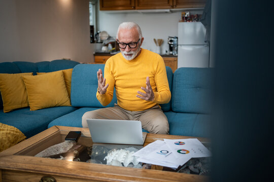 Senior man having video call remote working from home