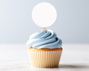 Vanilla cupcake with blue frosting and a blank round topper tag
