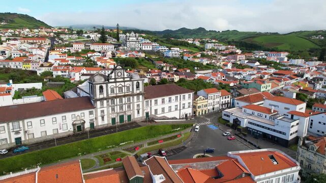 AZORES - 10.27.2025 - Great aerial footage moving over a church nestled in a green hillside of Horta on Faial Island.