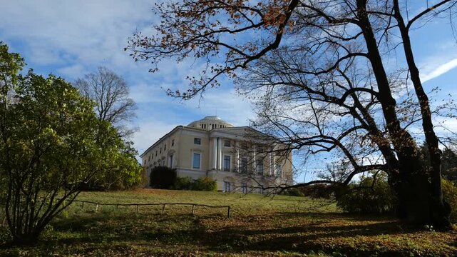 The Pavlovsk Palace is visible from the Slavyanka River at the top of a green slope, 18th-century Russian Imperial residence, suburb of St. Petersburg, Russia