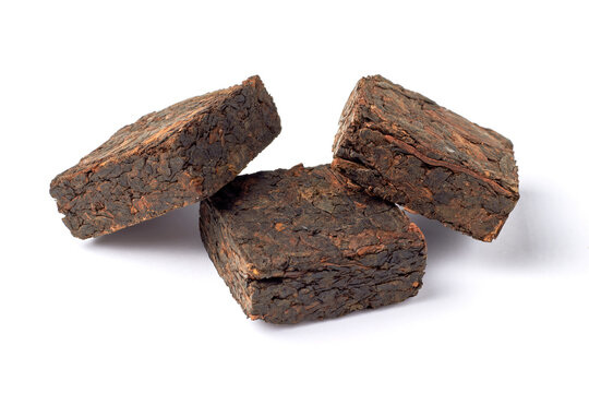 Three pieces of pressed fermented black tea isolated on white background.