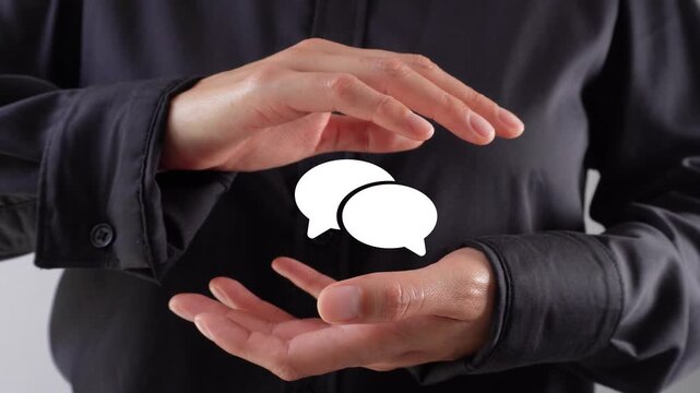 Close-up of a person's hands protecting an animation of a pair of thought bubbles