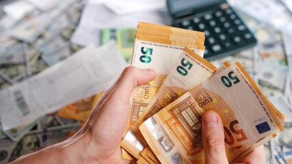 Man calculating money, monthly home expenses, taxes and bank account balance. - Powered by Adobe