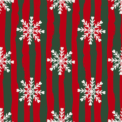 Vibrant Christmas seamless pattern with bold red and green vertical stripes, adorned with intricate white snowflakes for a festive holiday vibe.