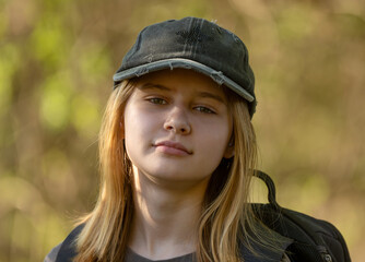 Portrait Of A Teenage Girl In A Cap On A Blurred Background