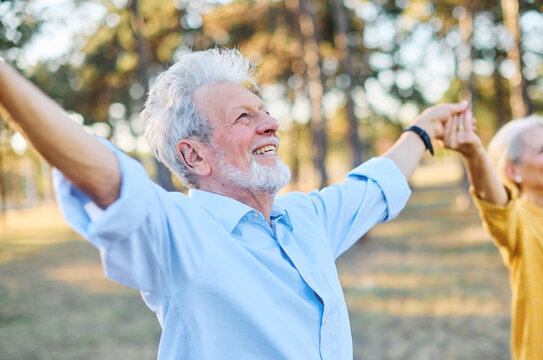 Happy active senior couple meditating and daydreaming and relaxing and nature outdoors