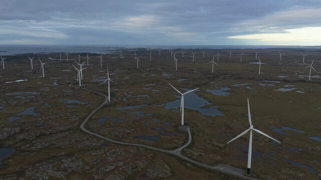 Eco-friendly wind towers dominate open land in Norway, seen aerially