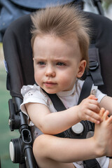 Portrait of a beautiful baby girl sitting in a stroller