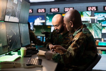Army officers use reconnaissance gear to do threat monitoring and target recognition, analyzing...