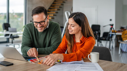 Couple designing home interior, choosing colors and planning renovation