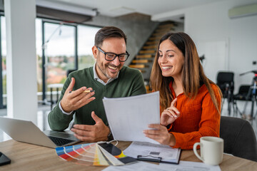Designers collaborating on office project discussing color swatches