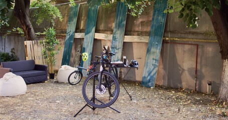 Two bicycles in backyard waiting for repair and maintenance with professional equipment as annual...