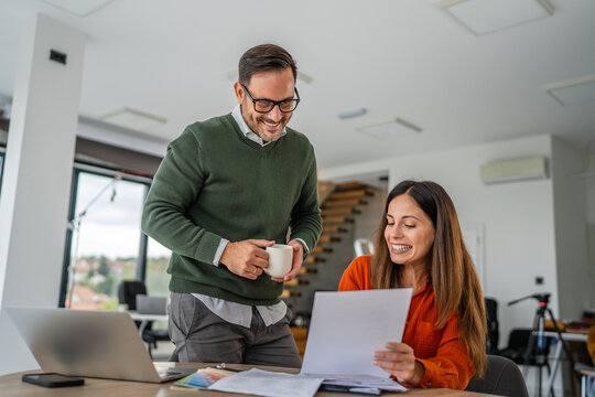 Business colleagues collaborating on documents in modern office