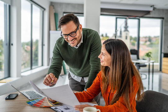 Designers collaborating on project planning in modern office - Powered by Adobe