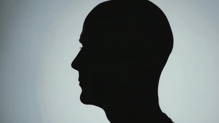 Simple yet striking silhouette of a person's head against a bright background. This can be used for various purposes including design and branding.