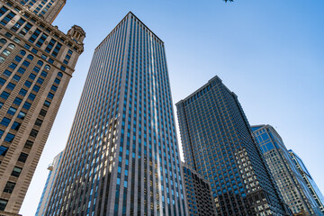 Fototapeta premium Reflective glass architecture. Architecture in business center. Building architecture. Business building. Glass building. Business city. City architecture. Modern glass building