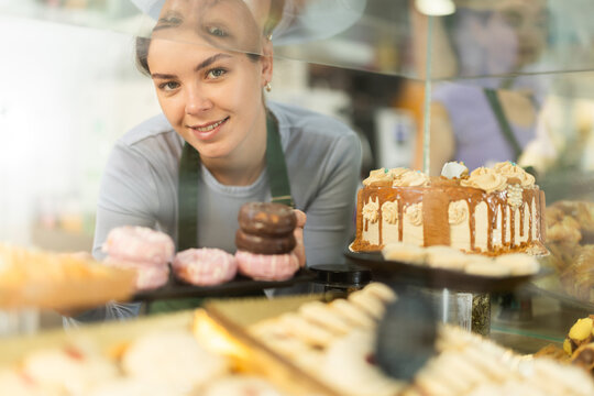 Female cafe employee offers to buy sweet desserts