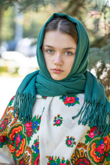 Portrait of a young beautiful woman with a scarf on her head
