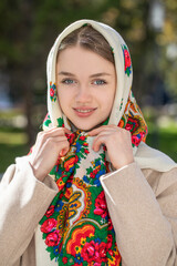 Portrait of a young beautiful woman with a scarf on her head