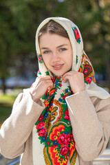 Portrait of a young beautiful woman with a scarf on her head
