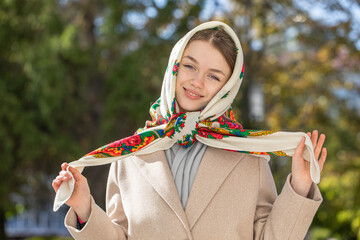 Portrait of a young beautiful woman with a scarf on her head