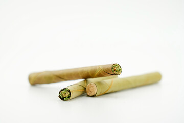 blunt cigar that has nature leaf and filled with cannabis. blunt marijuana tobacco leaf joint, marijuana blunt cigar, cannabis blunt cigarette prerolled Stick real photo white background