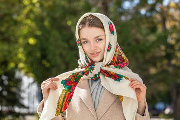 Portrait of a young beautiful woman with a scarf on her head