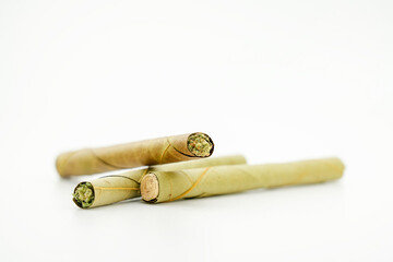 blunt cigar that has nature leaf and filled with cannabis. blunt marijuana tobacco leaf joint, marijuana blunt cigar, cannabis blunt cigarette prerolled Stick real photo white background