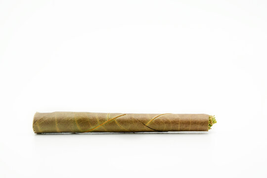 blunt cigar that has nature leaf and filled with cannabis. blunt marijuana tobacco leaf joint, marijuana blunt cigar, cannabis blunt cigarette prerolled Stick real photo white background