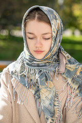 Portrait of a young beautiful woman with a scarf on her head