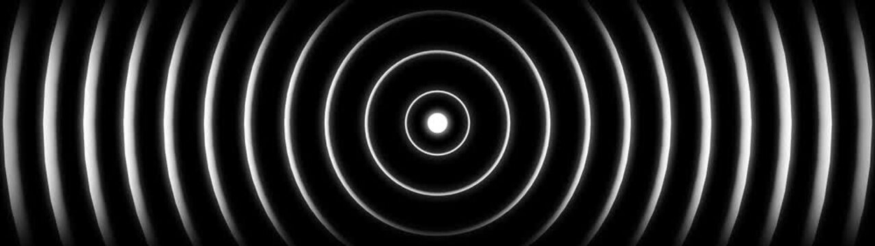 Abstract concentric circles with bright light in the center on a dark background image photo