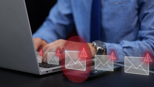 Digital security attack through phishing email on businessman laptop. Warning of data threat and cyber risk