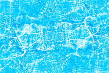 Blue water with ripples on the surface. Defocus blurred transparent blue colored clear calm water surface texture with splashes and bubbles. Water waves with shining pattern texture background.