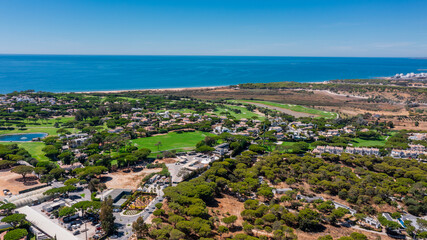 Vale de Lobo, Quinta de Lago, Faro, Portugal, aerial, Beachside wooded area, Calm shoreline featuring forested zones and sandy hillocks, Tranquil coastal scenery
