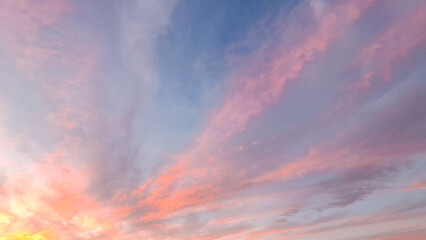 Vibrant sunset sky with colorful clouds, showcasing a blend of pink, orange, and blue hues, creating a serene atmosphere and captivating natural beauty
