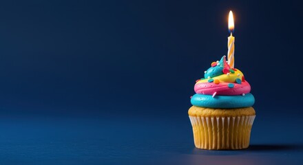 Miniature vanilla cupcake topped with brightly colored frosting, edible confetti sprinkles, and a decorative candle, celebrating a special event ,sugary ,bakery ,delicious