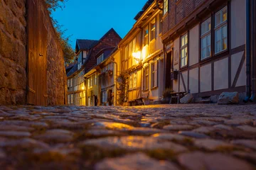 Fototapeten Enge Straßen Narrow streets with medieval houses in Quedlinburg, Germany  © golovianko