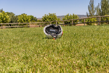 A white helmet on the green grass background