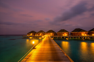 Night long exposure panorama with bungalows. Tropical island beach landscape exotic shore coast.  Summer vacation, holiday amazing nature. Relax paradise, Maldives.