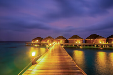 Night long exposure panorama with bungalows. Tropical island beach landscape exotic shore coast.  Summer vacation, holiday amazing nature. Relax paradise, Maldives.