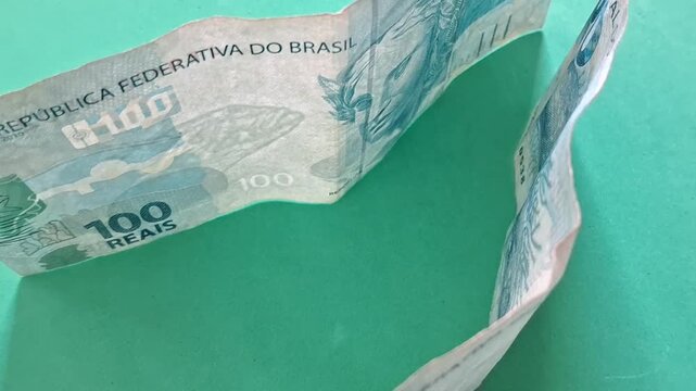 One hundred real notes on a green background